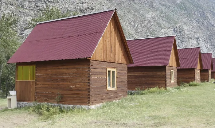 Framed Print : Wooden camping cabins near mountains