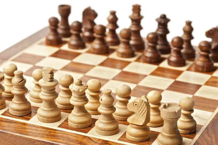 Framed Print : Wooden chess pieces on chessboard