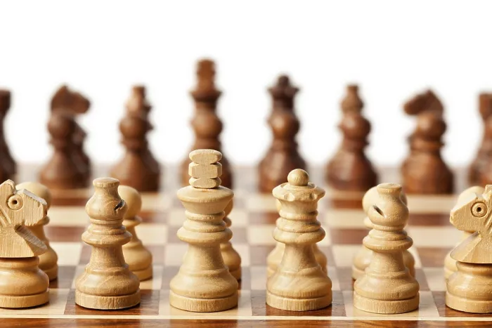 Framed Print : Wooden chess pieces on chessboard