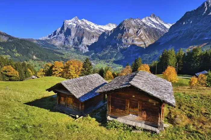 Framed Print : Wooden huts above Grindelwald, behind them Wetterhorn and Schreckhorn