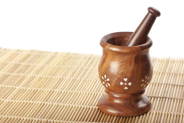 Framed Print : Wooden mortar with pestle on bamboo mat Framed Print : Wooden mortar with pestle on bamboo mat