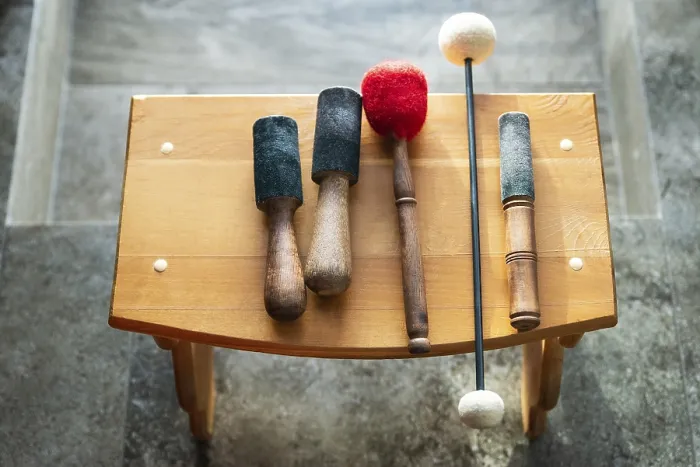 Framed Print : Wooden sticks for sound therapy with singing bowls in spa salon