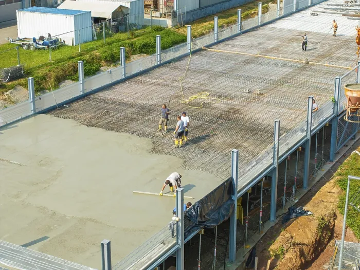 Framed Print : Workers on a construction site smoothing concrete surfaces and using tools Framed Print : Workers on a construction site smoothing concrete surfaces and using tools
