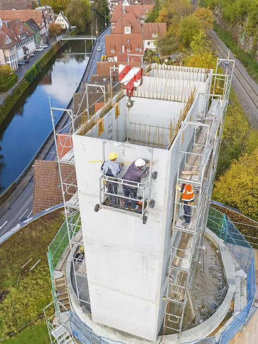 Framed Print : Workers on a high building in an urban landscape with water and surroundings