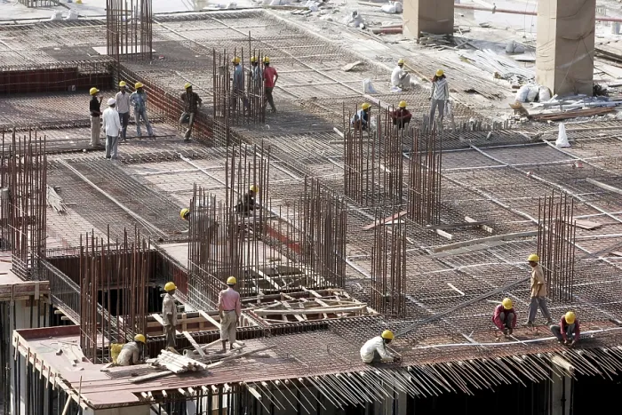 Framed Print : Workers working on the site of buildings being constructed on the site of earlier Jupiter mills
