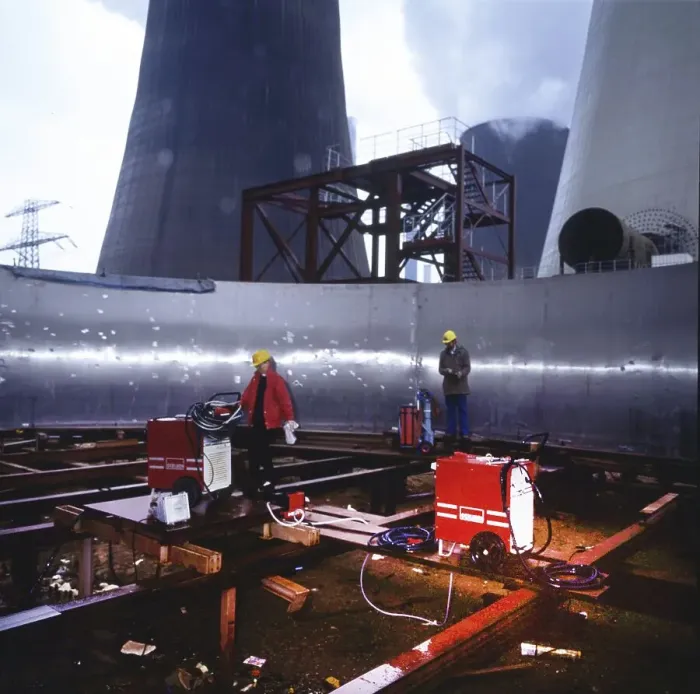 Framed Print : Workmen building a coal-fired power plant
