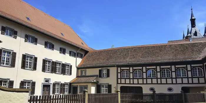 Framed Print : Wormser Hof half-timbered building under clear skies