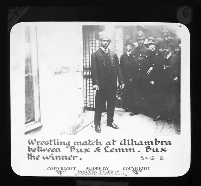 Framed Print : Wrestling match in the Alhmabra between Bux and Lemm, Bux wins, Laterna Magica by Walter Tyler Ltd. Alhambra Theatre, London, 5 September 1910