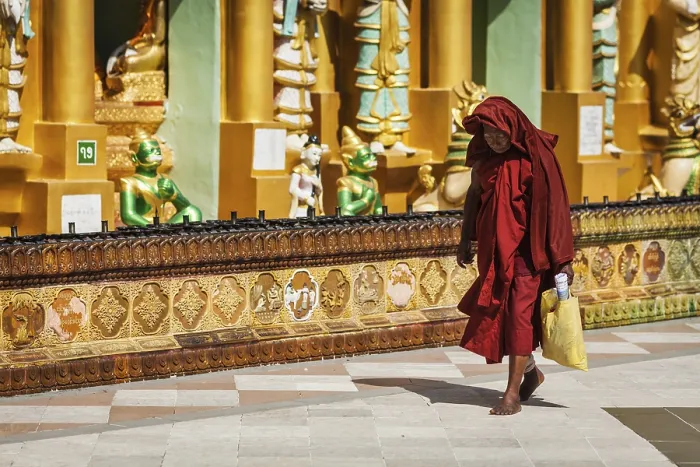 Framed Print : YANGON, MYANMAR, JANUARY 3, 2014: Old Buddhist monk walking in Shwedagon Paya pagoda