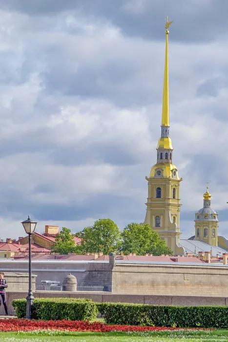 Framed Print : Yellow church tower towering in cloudy sky surrounded by trees and cityscape