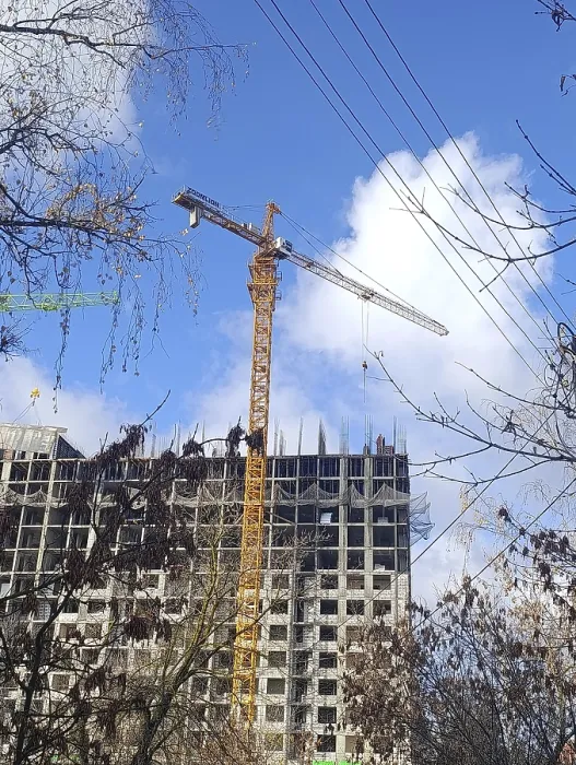 Framed Print : A yellow crane is building a house out of concrete slabs Framed Print : A yellow crane is building a house out of concrete slabs