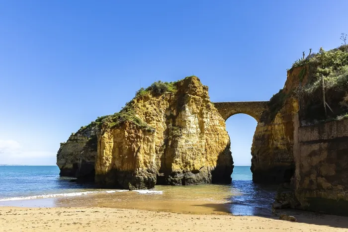 Framed Print : Yellow rocks and cliffs on a sandy beach