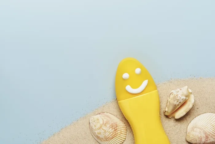 Framed Print : Yellow tube with happy sunscreen face