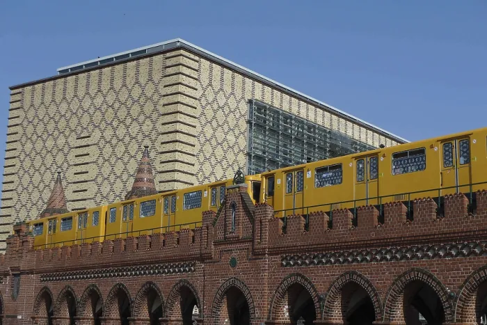 Framed Print : A yellow underground train crosses a brick bridge in Berlin with modern architecture behind it Framed Print : A yellow underground train crosses a brick bridge in Berlin with modern architecture behind it