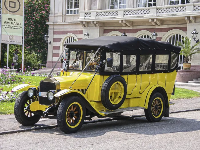 Framed Print : Yellow vintage bus in front of theatre