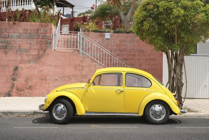 Framed Print : Yellow VW Beetle stands in front of red wall on the Canary Island La Palma