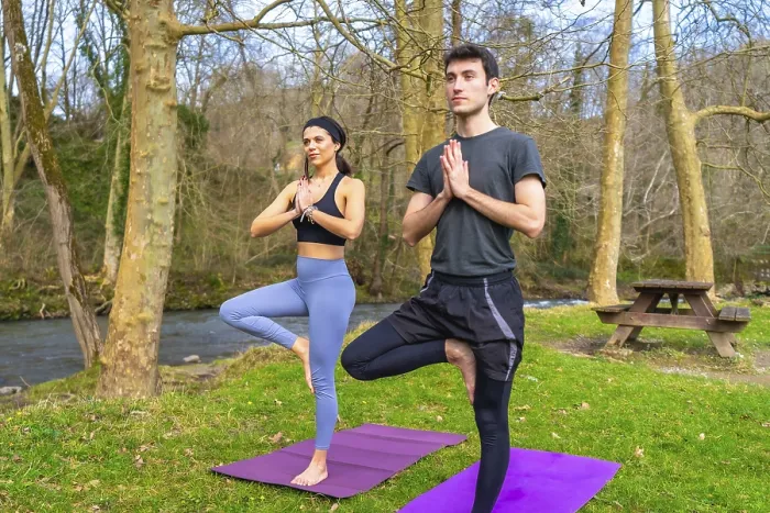Framed Print : Yoga instructors performing the tree pose by a river in a forest Framed Print : Yoga instructors performing the tree pose by a river in a forest