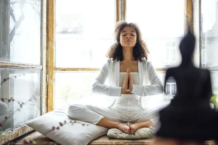 Framed Print : Young adult happy fit slim healthy African American ethnic woman wearing white clothes sitting in yoga pose at home in