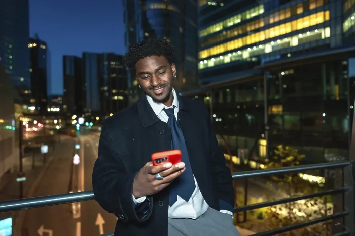 Framed Print : Young black businessman on an elevated walkway at night Framed Print : Young black businessman on an elevated walkway at night