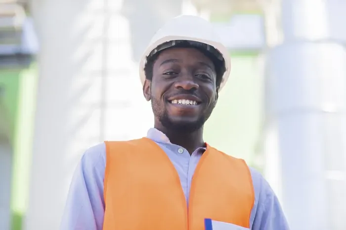Framed Print : Young black man working outside as technician with helmet and safety vest Framed Print : Young black man working outside as technician with helmet and safety vest