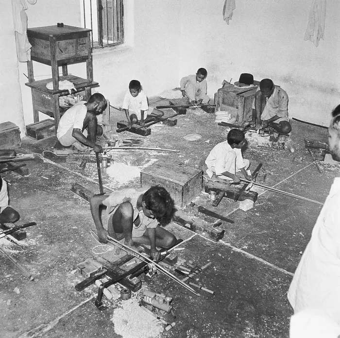 Framed Print : Young boys using portable rotating lathe applying lacquer wringtinforia wood, painting lacquer toys, Channapatna, Karnataka