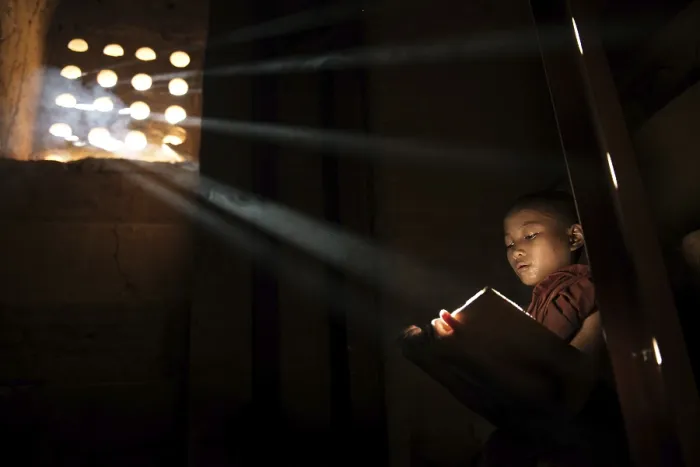Framed Print : Young Buddhist monk reading in monastery Framed Print : Young Buddhist monk reading in monastery