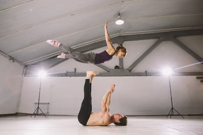 Framed Print : Young couple Couple practicing acro yoga in gym Framed Print : Young couple Couple practicing acro yoga in gym