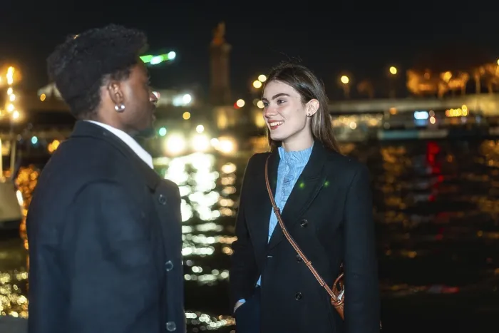 Framed Print : Young diverse couple standing by paris river at night
