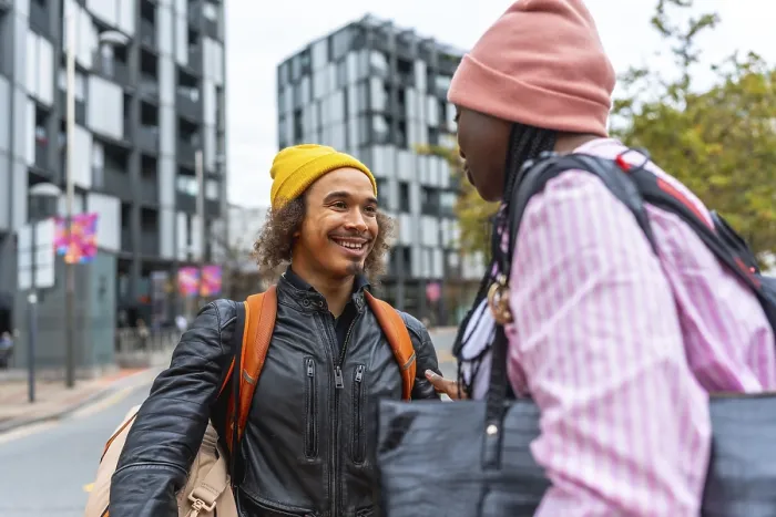 Framed Print : Young diverse friends smiling and chatting on a city street