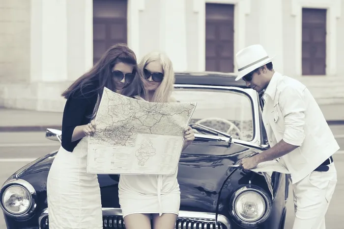 Framed Print : Young fashion people with a road map next to vintage car Framed Print : Young fashion people with a road map next to vintage car