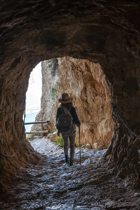Framed Print : A young hiker in the tunnel of the trail in the Penon de Ifach Natural Park with the city of Calpe in the background Framed Print : A young hiker in the tunnel of the trail in the Penon de Ifach Natural Park with the city of Calpe in the background