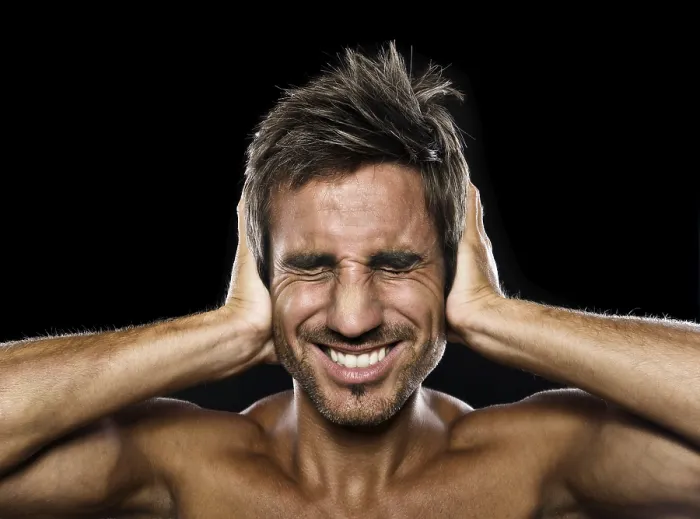 Framed Print : Young man holding his hands against his ears Framed Print : Young man holding his hands against his ears