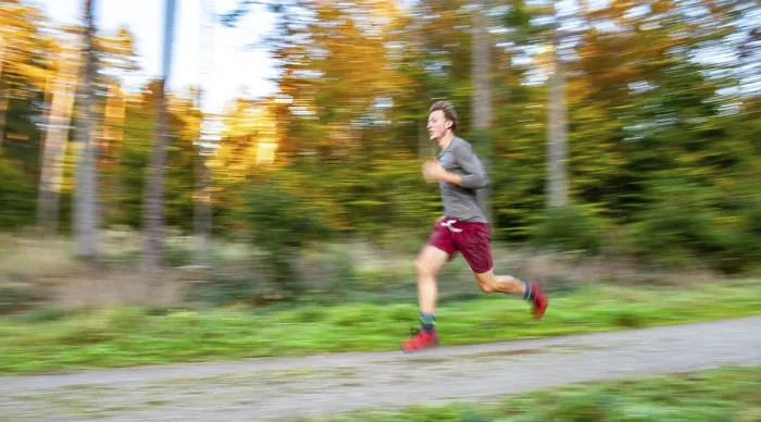 Framed Print : Young man jogging in the autumnal forest