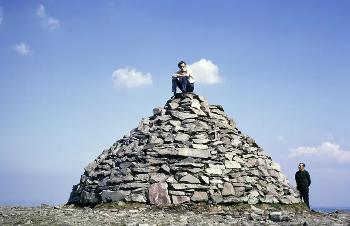 Framed Print : Young man sitting on a cairn on the summit of Dunkery Beacon, the highest point in Exmoor National Park, Somerset, England 1, 705 ft 520 metres, 1967