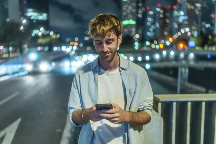 Framed Print : Young man standing on a city bridge at night Framed Print : Young man standing on a city bridge at night