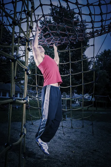 Framed Print : Young man by training at outdoor fitness facility