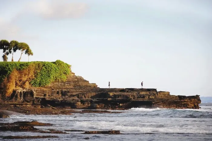 Framed Print : Young man and woman back to back holding mobile phones in a scenic place in Bali