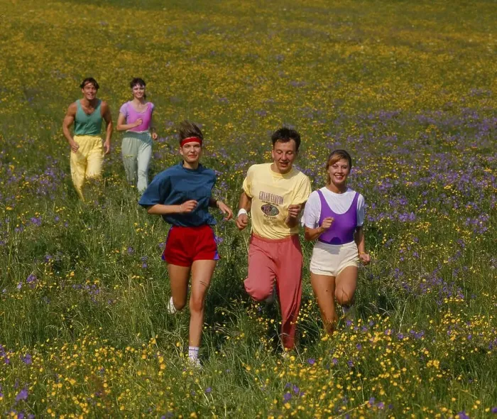 Framed Print : Young people jogging through flower meadow Framed Print : Young people jogging through flower meadow