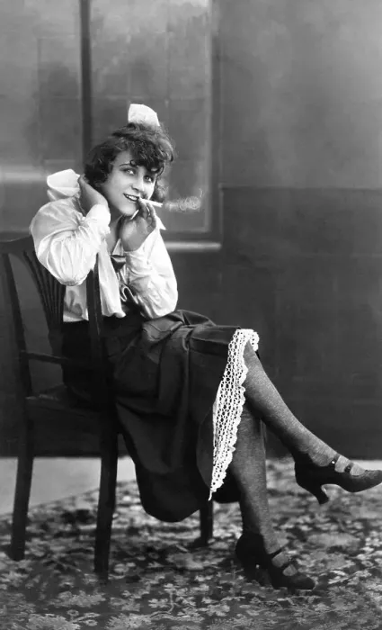Framed Print : Young, pretty woman sitting on a chair smoking Framed Print : Young, pretty woman sitting on a chair smoking