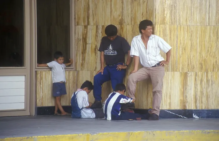 Framed Print : Young shoe cleaner at work in Iquitos
