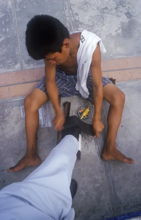 Framed Print : Young shoe cleaner working in Iquitos