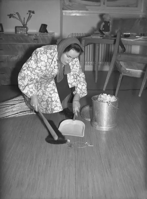 Framed Print : The young Uppsala student Eva-Britt Ohlsson cleans and sweeps the floor from dust and dirt on a February day in 1940