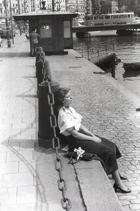 Framed Print : Young woman 1954. She is sitting in the sunshine with closed eyes enjoying the fine weather. She is wearing a white shirt and a skirt in Corduroy fabric