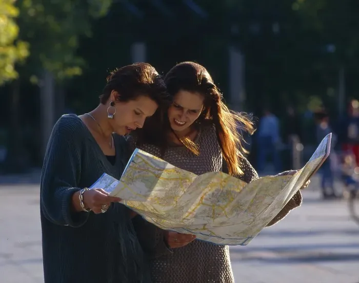 Framed Print : Two young woman with a city map Framed Print : Two young woman with a city map