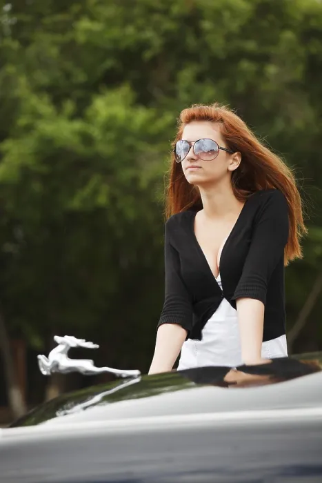 Framed Print : Young woman by the classic car