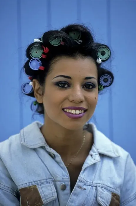 Framed Print : Young woman with curlers in her hair