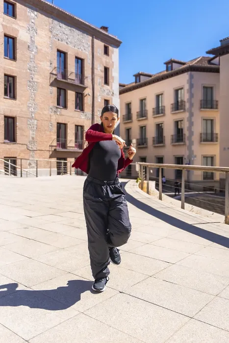 Framed Print : Young woman dancer performing dynamic contemporary routine on a sunny city street