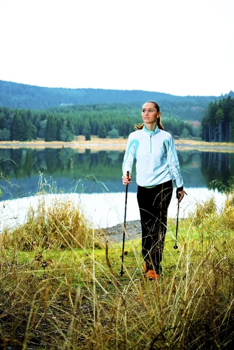 Framed Print : Young woman doing nordic walking beside a lake Framed Print : Young woman doing nordic walking beside a lake