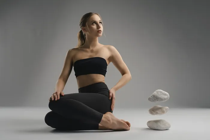 Framed Print : A young woman dressed in a black crop top and leggings sits in a serene yoga pose Framed Print : A young woman dressed in a black crop top and leggings sits in a serene yoga pose