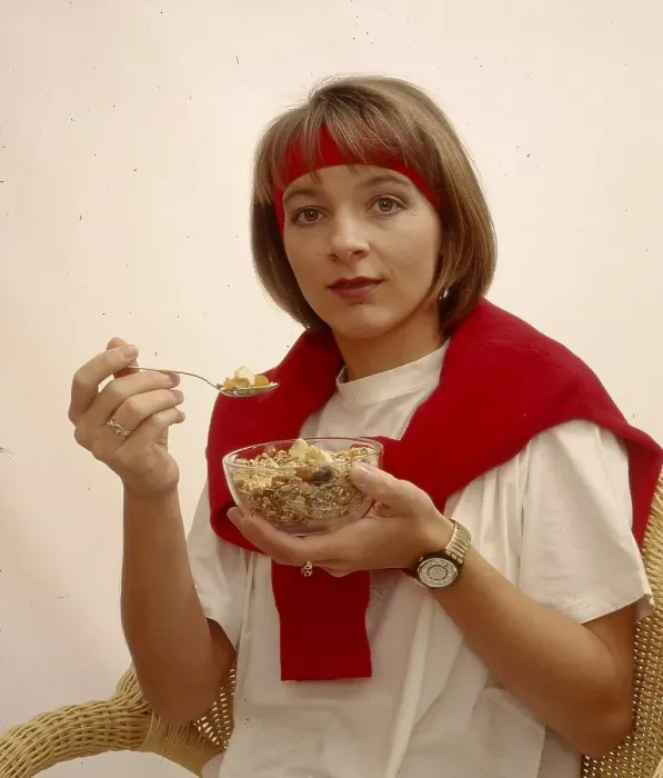 Framed Print : Young woman eating muesli